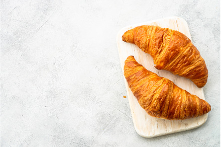 Croissant on cutting board at white, a Food & Drink Photo by Nadia-nb