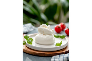 Burrata cheese on plate, copy space, a Food & Drink Photo by Fascinadora