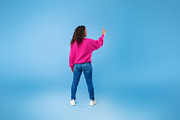 Back view of millennial African American lady touching imaginary screen, pressi, a Photo by Prostock-Studio (Thumbnail 2 of 2)