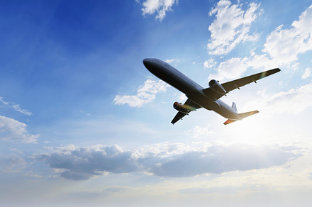 Airplane flying in the air with sunlight shining in blue sky background. Travel, a Transportation Photo by Ministocker