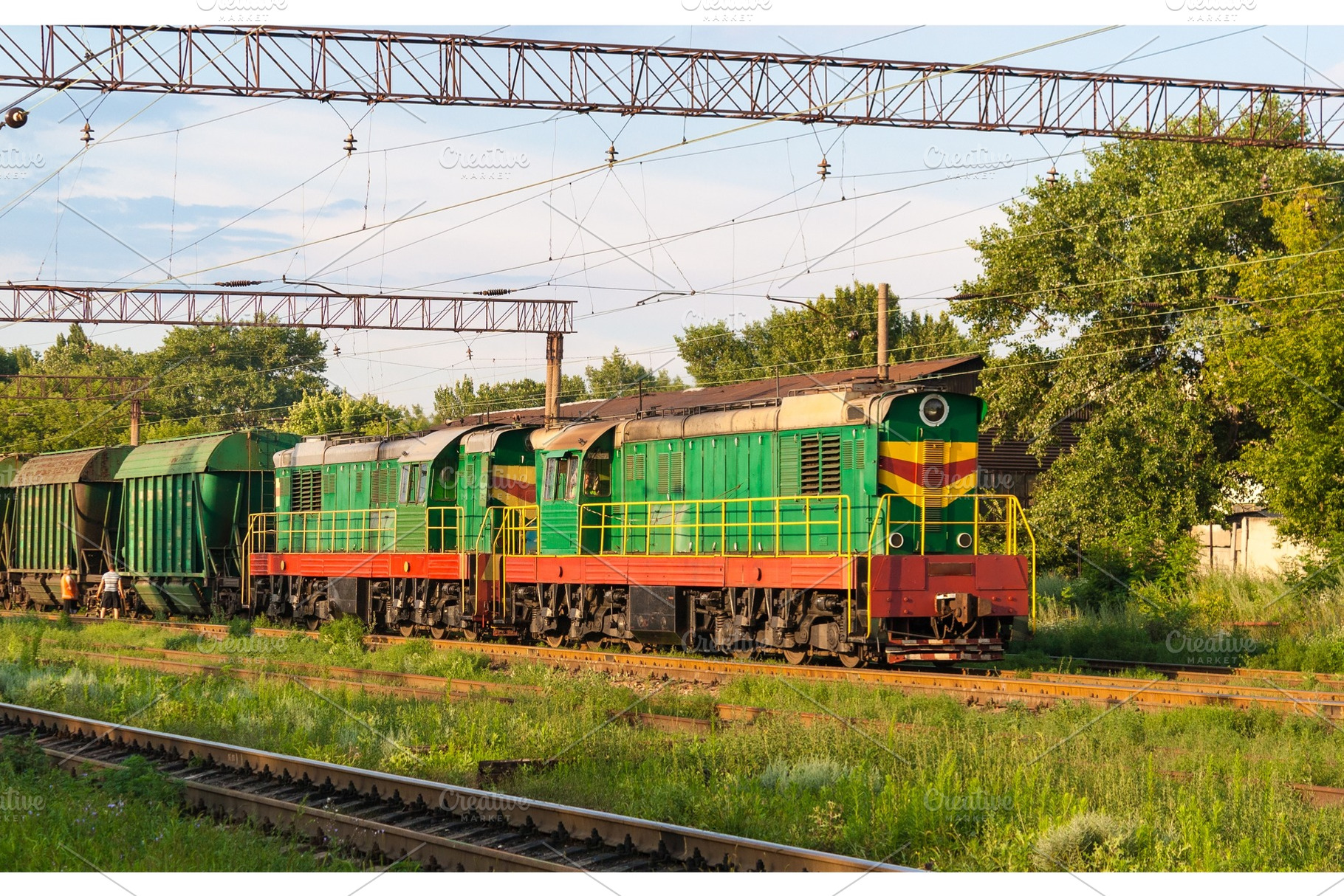 Two shunters with freight train at a station, a Transportation Photo by Leonid Andronov