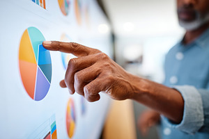 Business professional analyzes data trends on touchscreen display in modern off, a Photo by AlyaAnd
