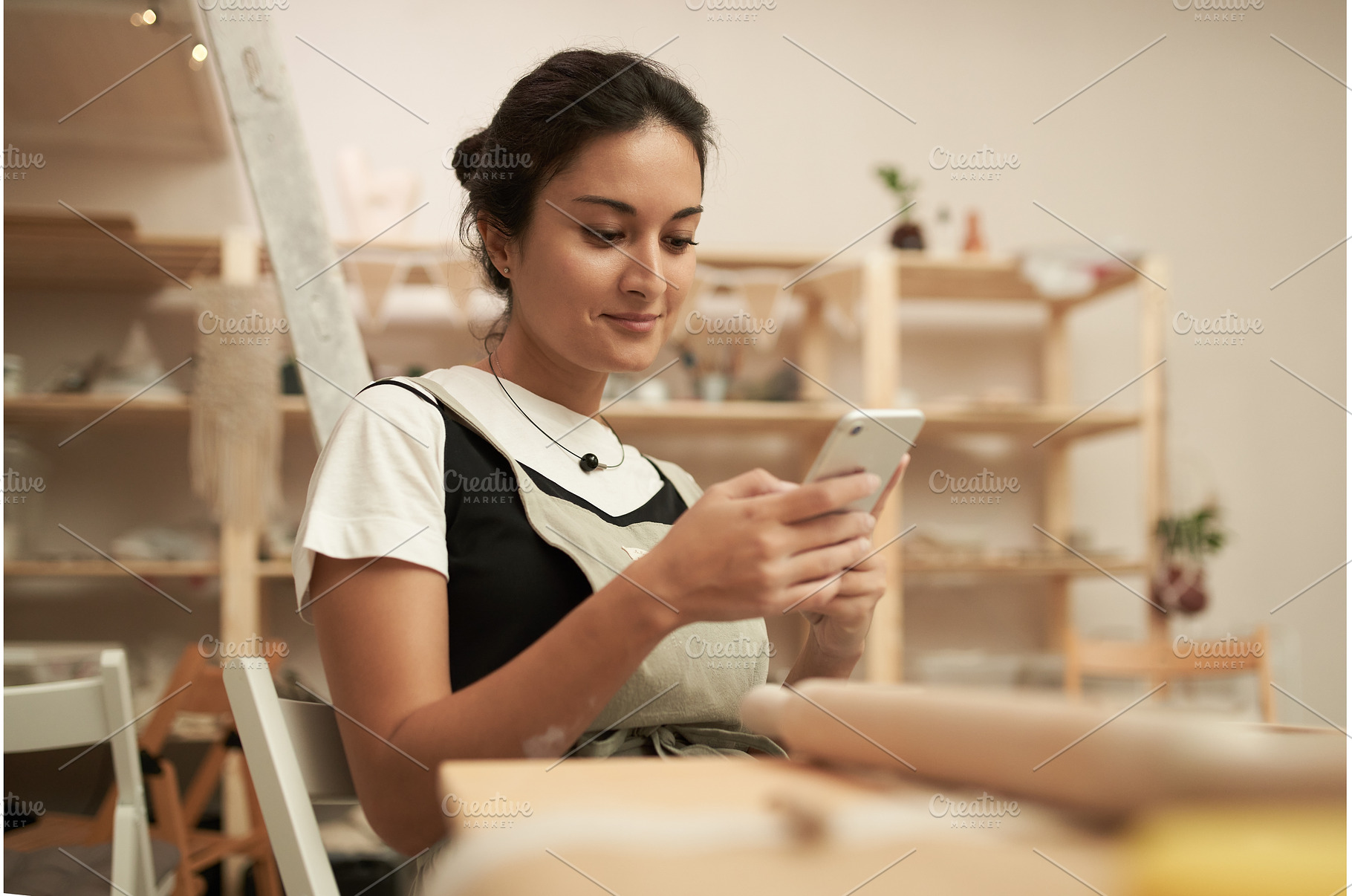 Woman using smartphone in pottery, a Person Photo by Sergey Mironov's store