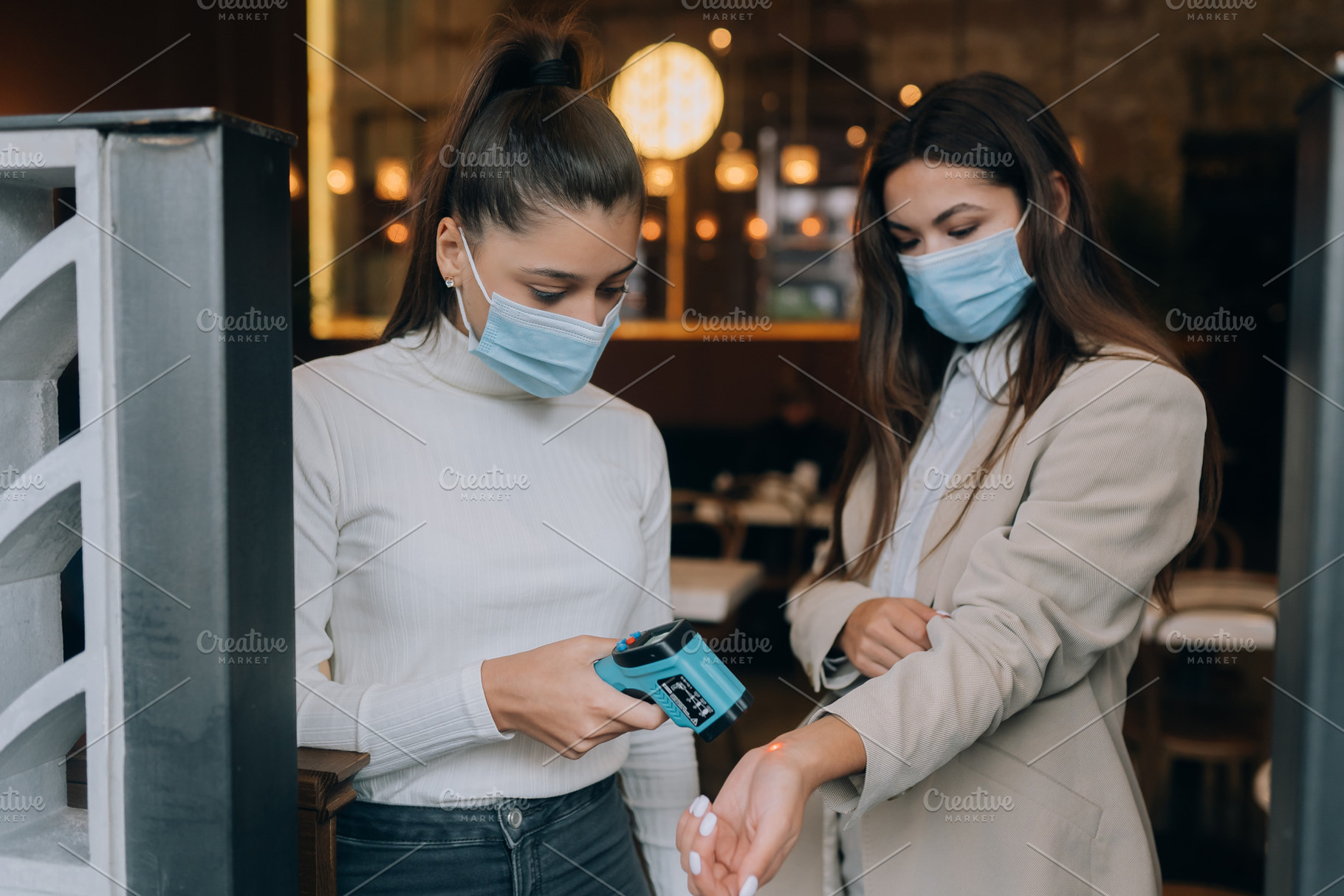 Woman measuring body temperature with contactless body thermometer, a Person Photo by Tekso