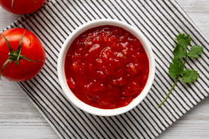 Organic Tomato and Cilantro Salsa in a Bowl, top view., a Food & Drink Photo by LiudmylaChuhunova