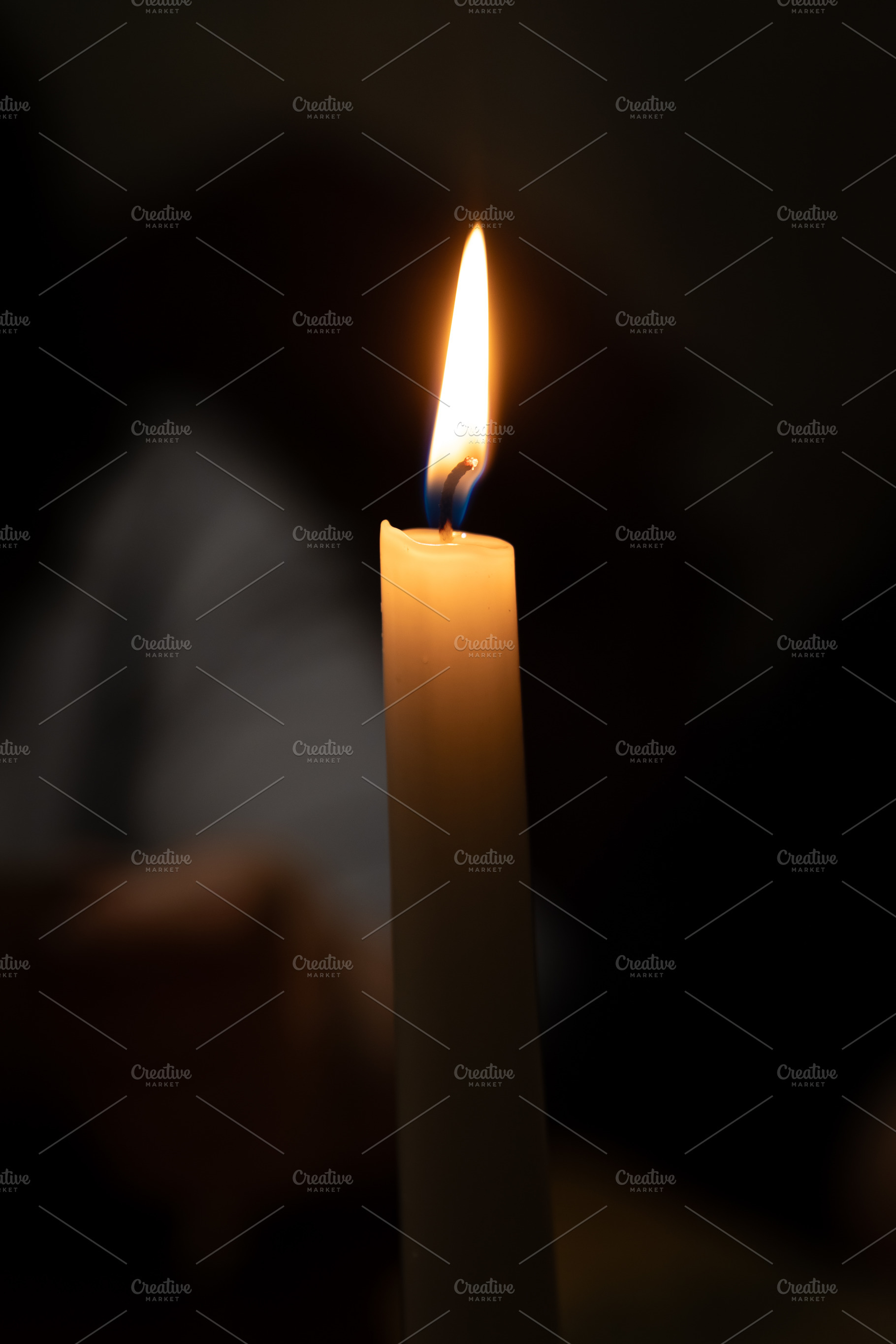 Close-up of a lit candle against a dark, blurred background, cre, a Holiday Photo by Ales Munt