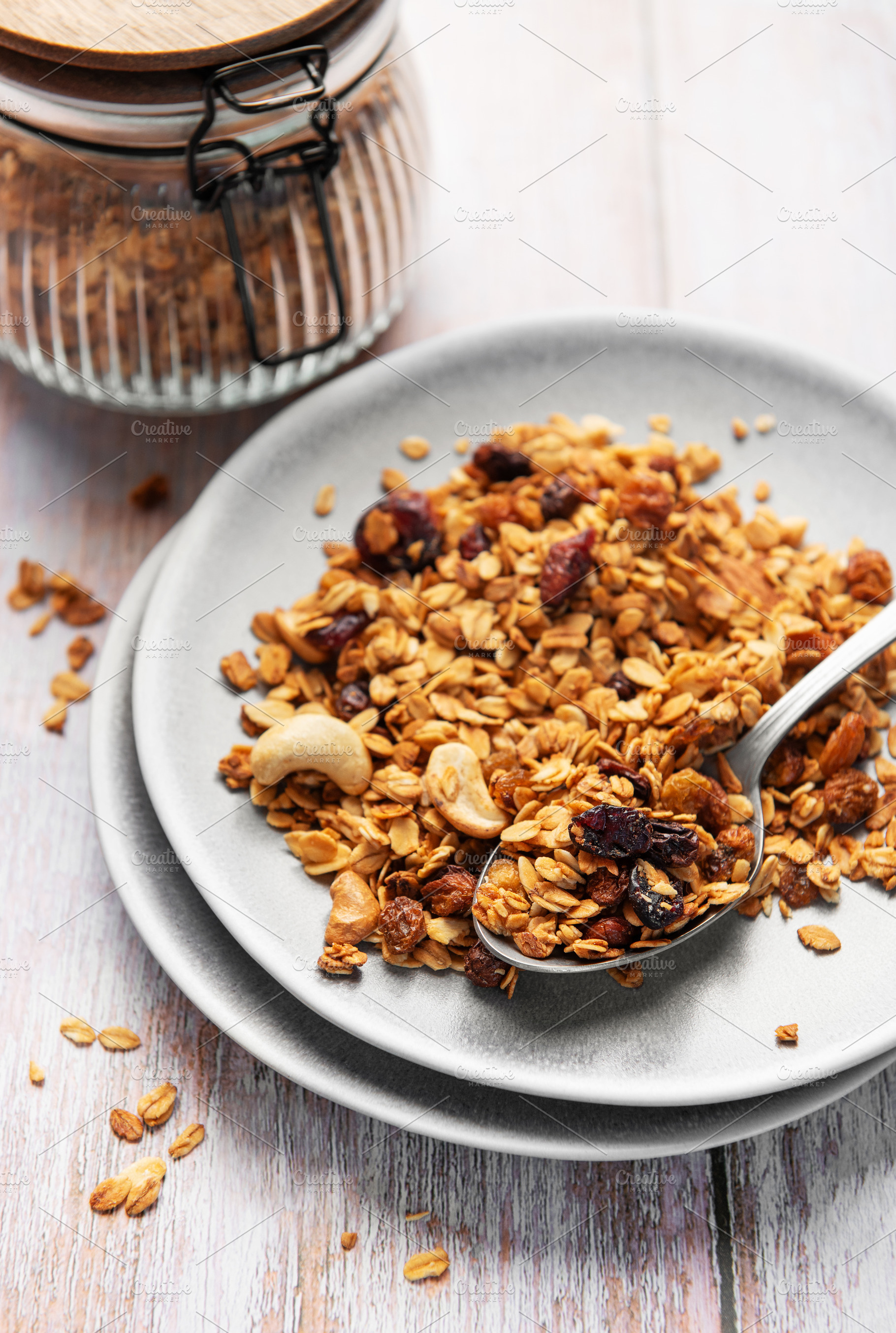 Healthy homemade granola mix on plate with spoon, a Food & Drink Photo by Olena Rudo