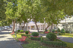 Sunlit public park with walking path and benches, an Architecture Photo by DanFLCreativo