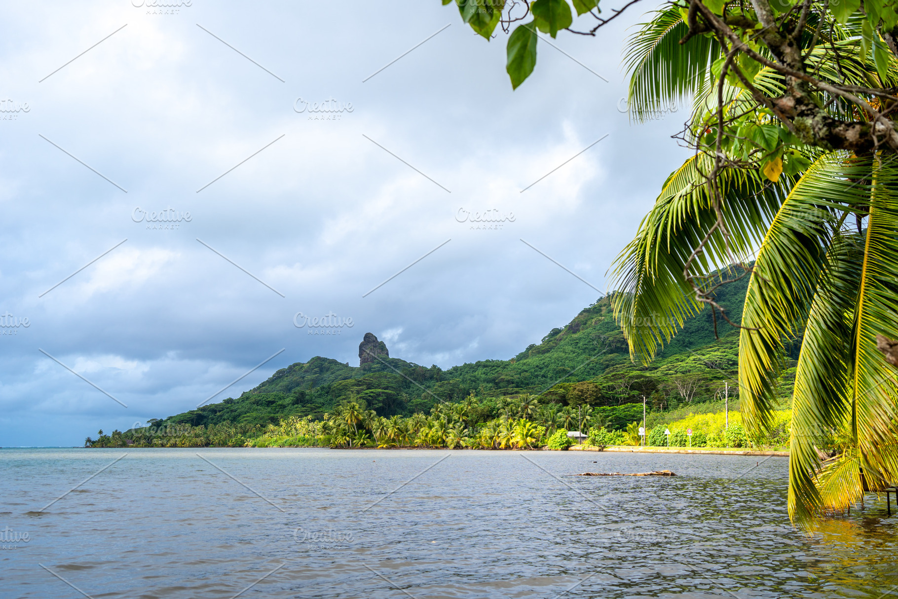 Maroe Bay with lush hills and calm waters in Huahine, French Pol, a Nature Photo by GoodGoods