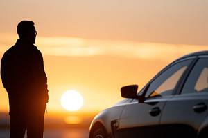 Silhouette of a man standing next to, a Transportation Photo by MistyDay