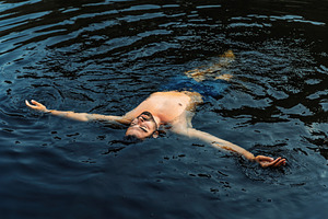 Relaxed man floating in natural dark, a Holiday Photo by Perpis