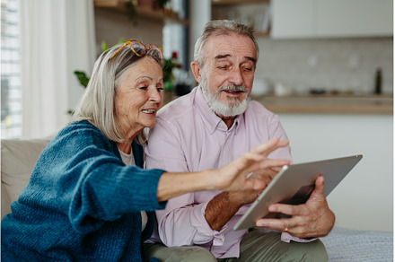 Senior couple scrolling tablet in, a Person Photo by HalfPoint