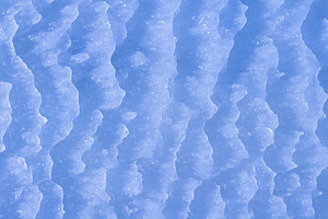 Blue rough ice texture with snow, winter background, a Photo by MDBildes