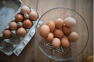 Fresh brown eggs in carton and glass, a Food & Drink Photo by HalfPoint