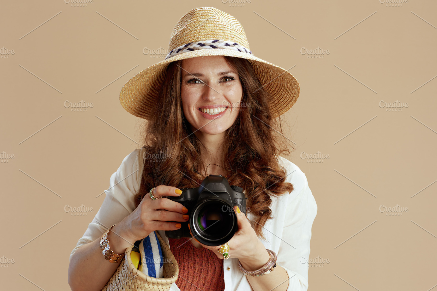 happy stylish woman in blouse and shorts isolated on beige, a Person Photo by Alliance Images