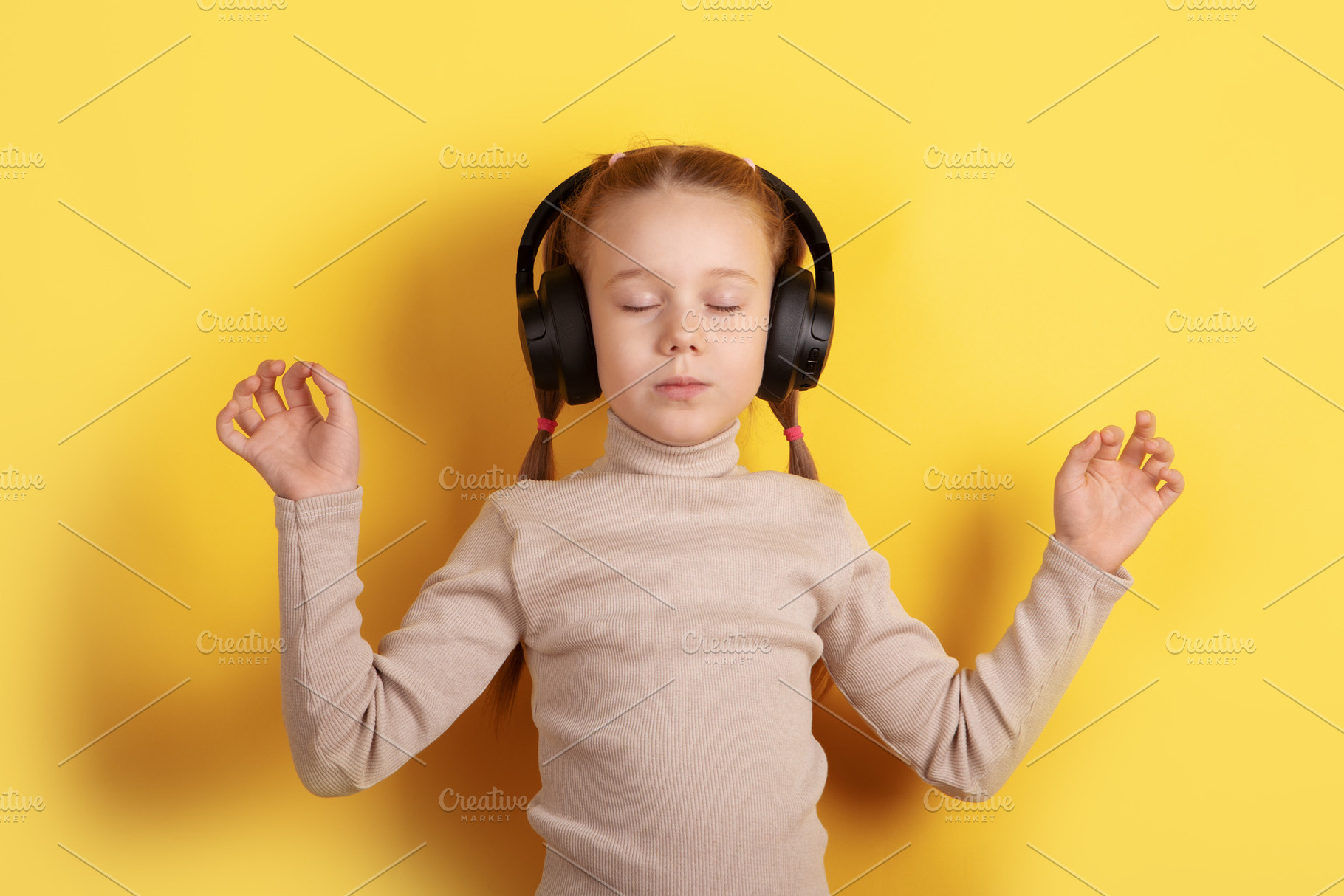 Calm young girl with headphones enjoying music, eyes closed, yel, a Person Photo by Ales Munt