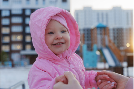 Happy child in pink jacket enjoys