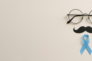 Men health awareness concept with mustache and ribbon on light b, a Photo by Dvoevnore photos