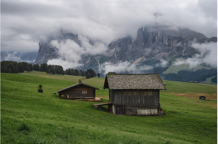 Wooden shelter huts in Alpe Di Siusi, a Nature Photo by Igor Tichonow