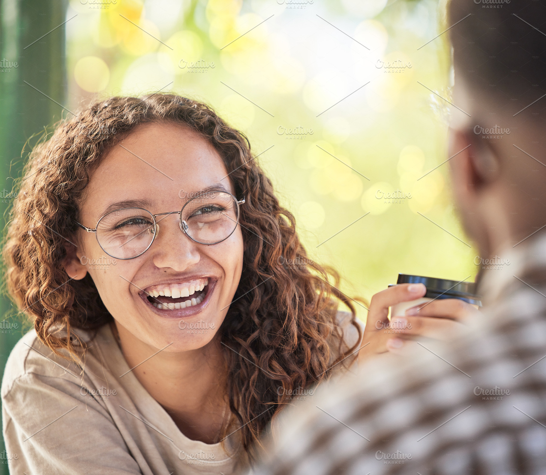 Face, happy or date and a black woman drinking coffee in the park with her boyfriend during summer. Smile, love and dating with a young female smiling at her partner for romance or affection, a Photo by Peopleimages.com