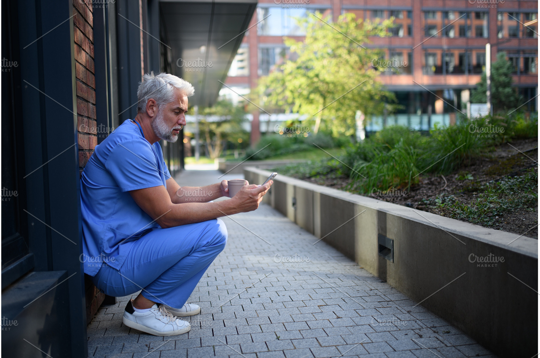 Healthcare worker outside hospital, a Health & Medical Photo by HalfPoint