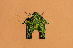 House symbol with grass texture cut on paper,sustainable housing, a Photo by salmon.black