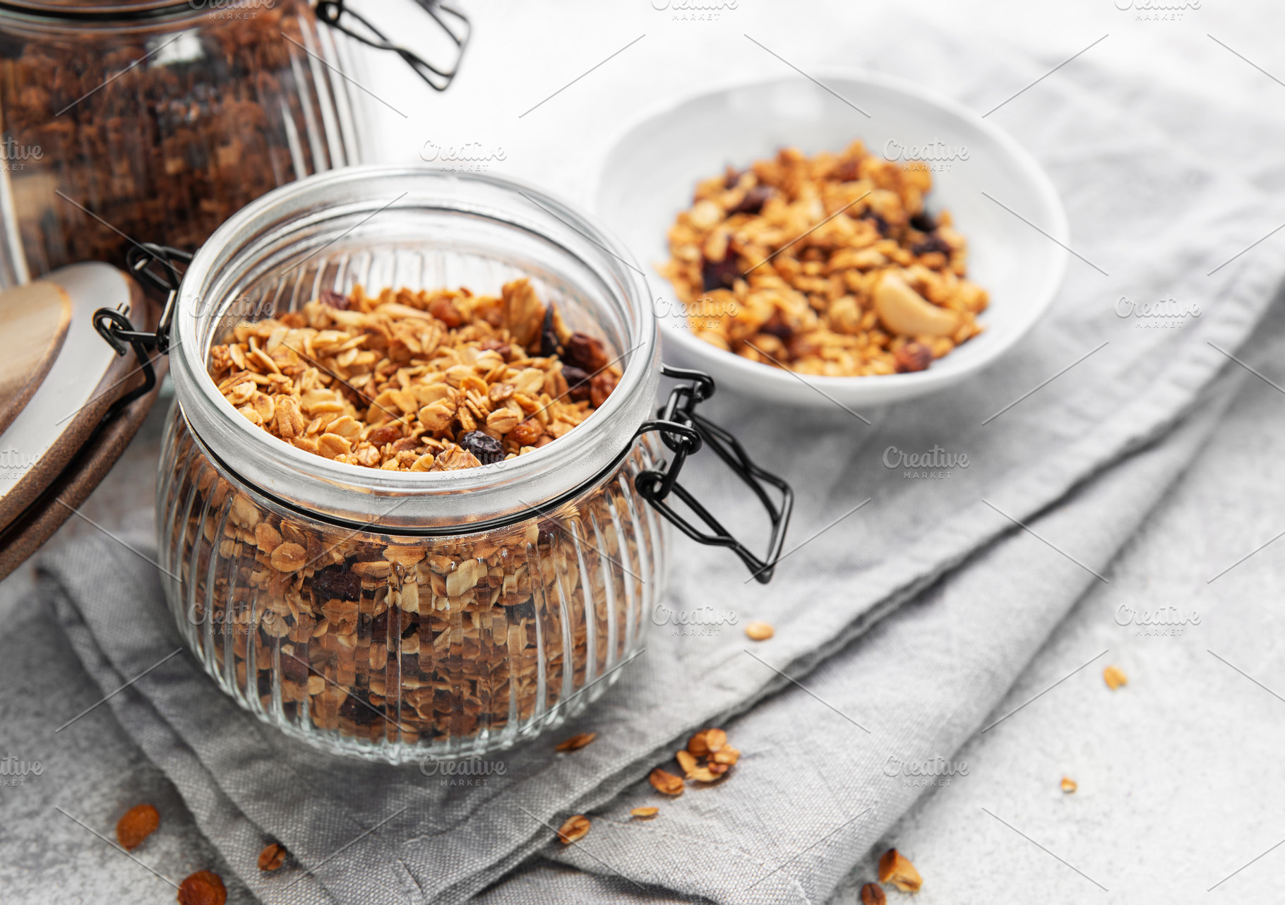 Granola cereal in glass jar ready for healthy breakfast, a Food & Drink Photo by Olena Rudo