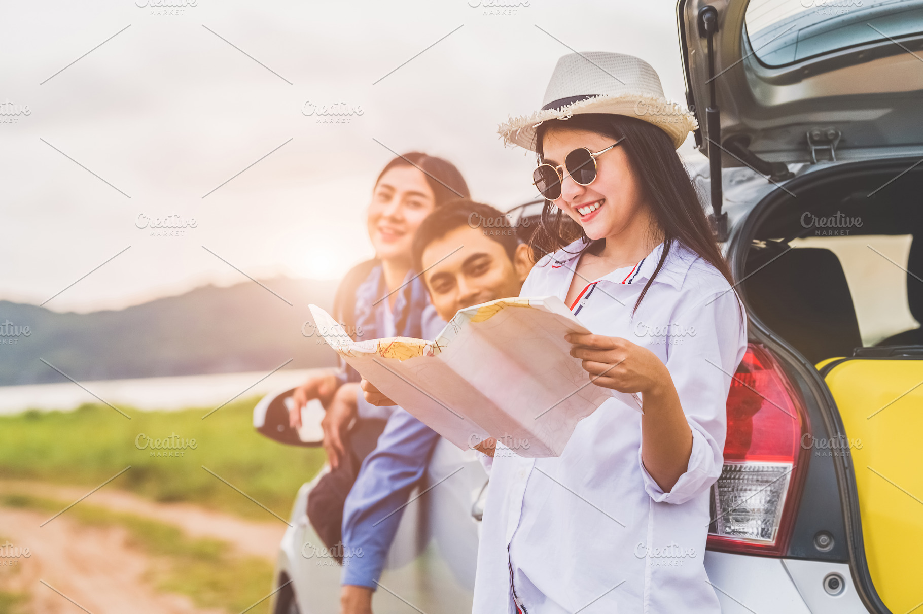 Happy Asian woman and her friends standing by car. Young girl ha, a Person Photo by Ministocker