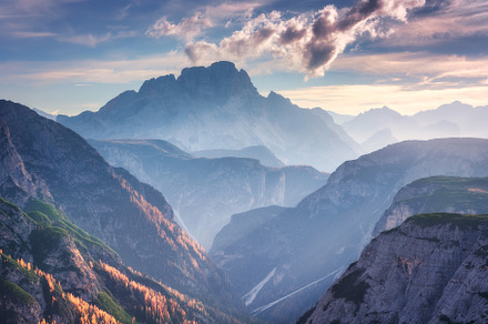 Mountain canyon lighted by bright sunbeams at sunset, a Nature Photo by den-belitsky