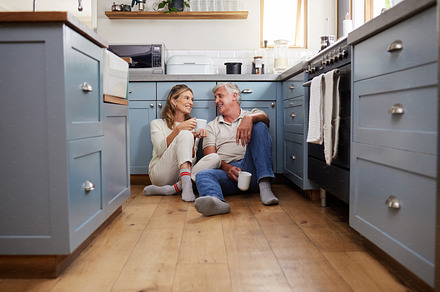 Coffee, morning communication and senior couple talking on the kitchen floor together in their house. Happy, calm and peace for elderly man and woman with tea drink and conversation during retirement, a Photo by Peopleimages.com