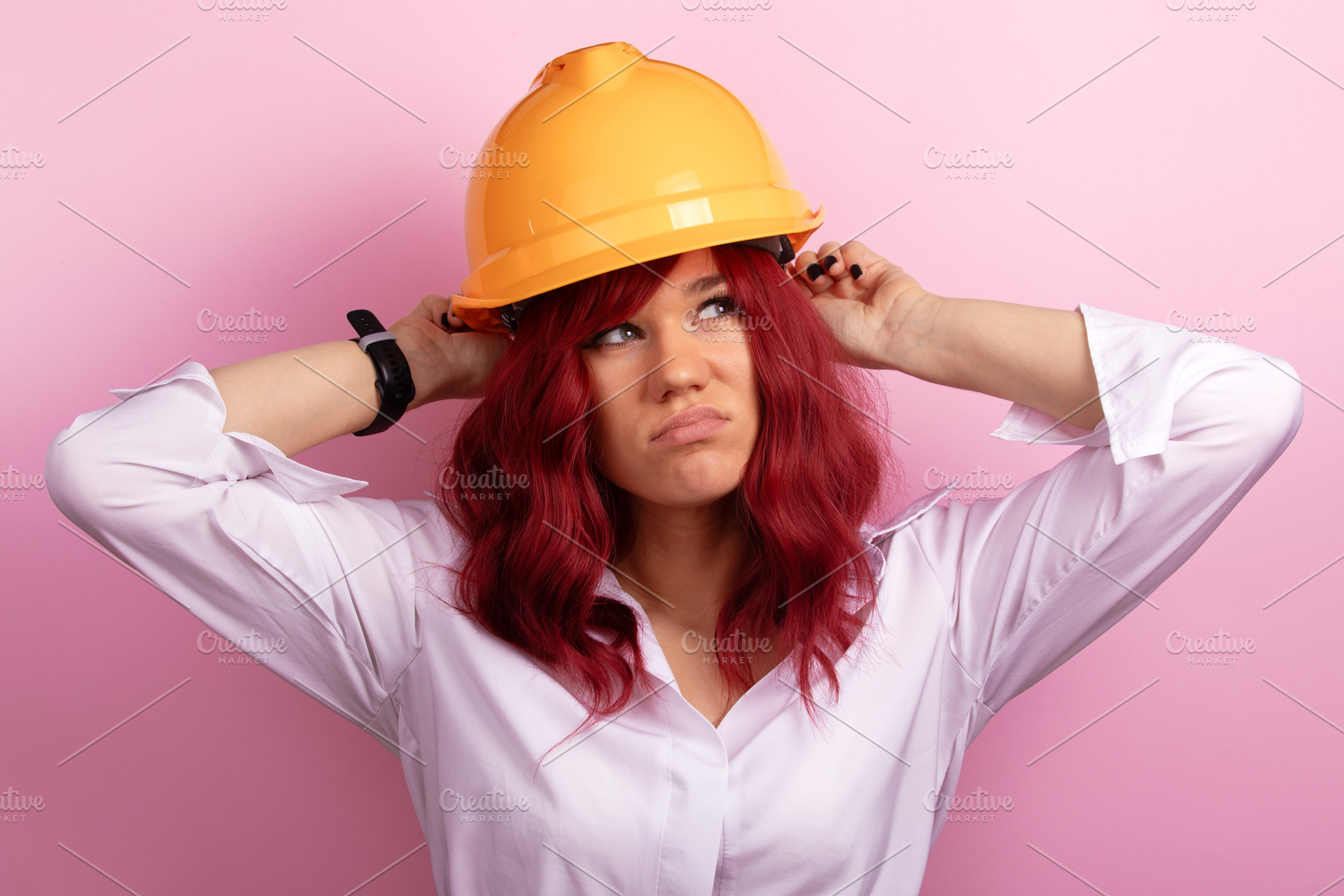 Confident woman with red hair wearing a construction helmet, pos, a Person Photo by Ales Munt