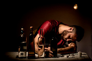 Young man with beard stock photo containing bottles and cigarettes