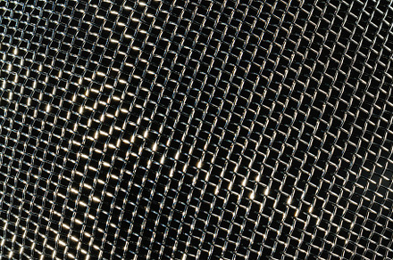 Monochrome texture of a shiny metal colander or grate. Abstract, an Abstract Photo by Eugene_Photo