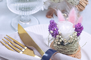 Easter table setting decorated with flower arrangement and golden cutlery, vert, a Food & Drink Photo by iuliia_n