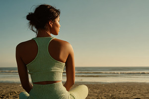 Woman meditating at sunset, a Photo by Beautiful things