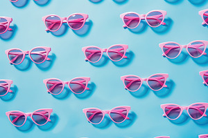 Pattern of pink sunglasses on blue background, a Photo by AlyaAnd