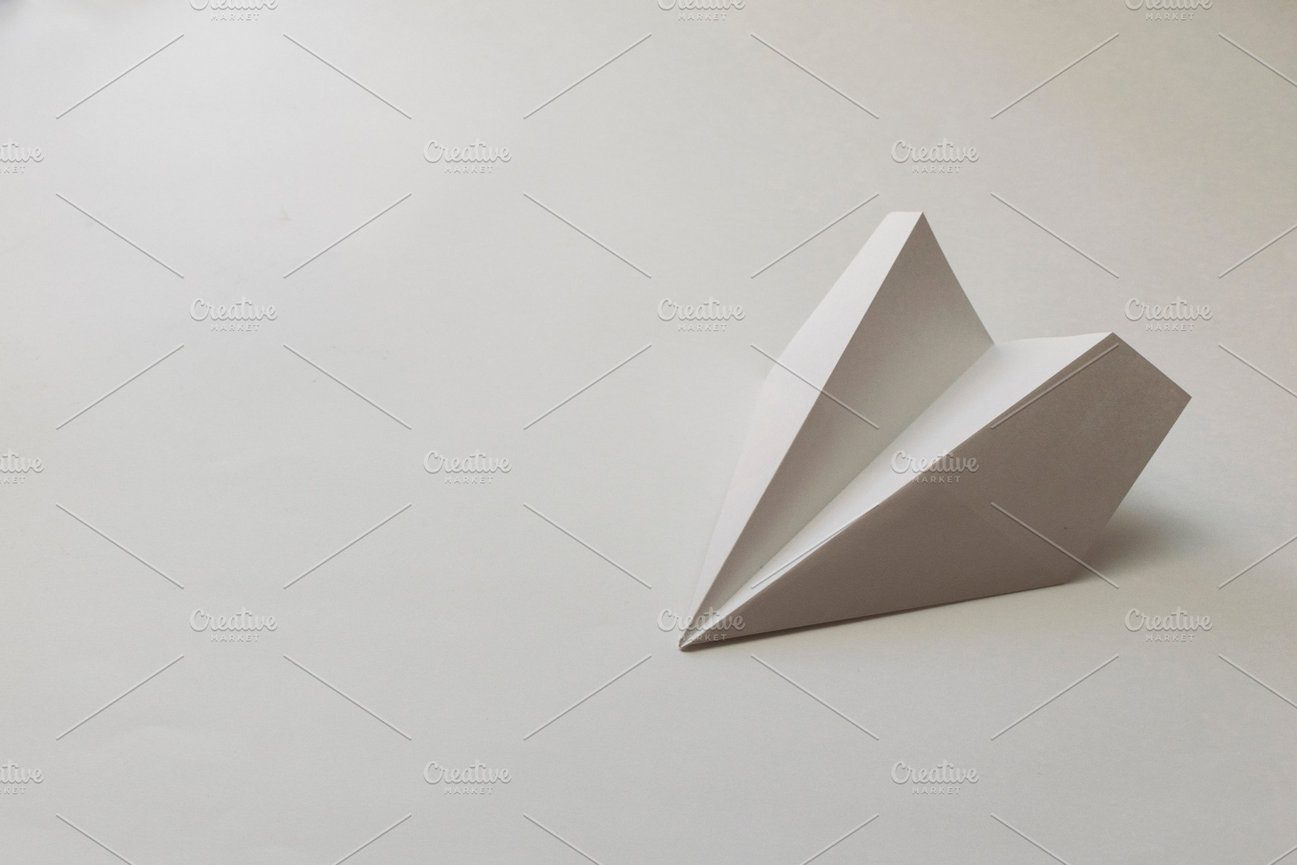 Paper plane on a white background, a Transportation Photo by Ti-Di