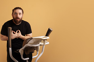 Shocked man in black shirt holding chest while standing on ellip, a Person Photo by Ales Munt