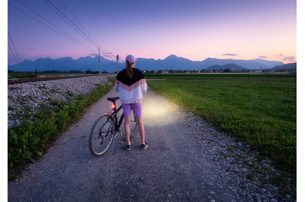 Woman is standing with mountain bike