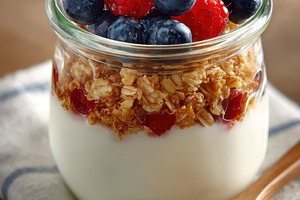 Layered yogurt parfait with berries and granola, a Food & Drink Photo by AlyaAnd
