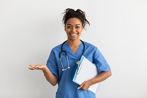 Portrait of black doctor smiling and posing to camera, a Photo by Prostock-Studio