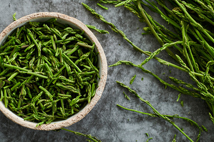 cut wild asparagus in a bowl, web banner, a Photo by Nito