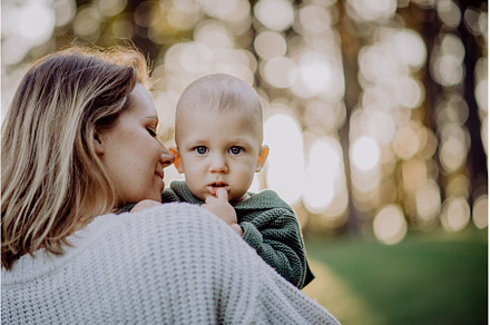 Mother holding her little baby son, a Nature Photo by HalfPoint