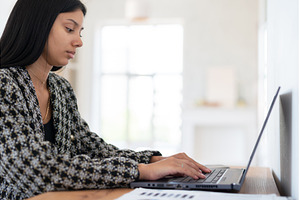 Student doing home work with laptop, a School & Education Photo by undrey