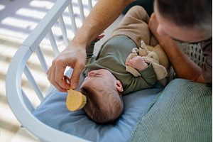 Father putting the baby to sleep, a Person Photo by HalfPoint