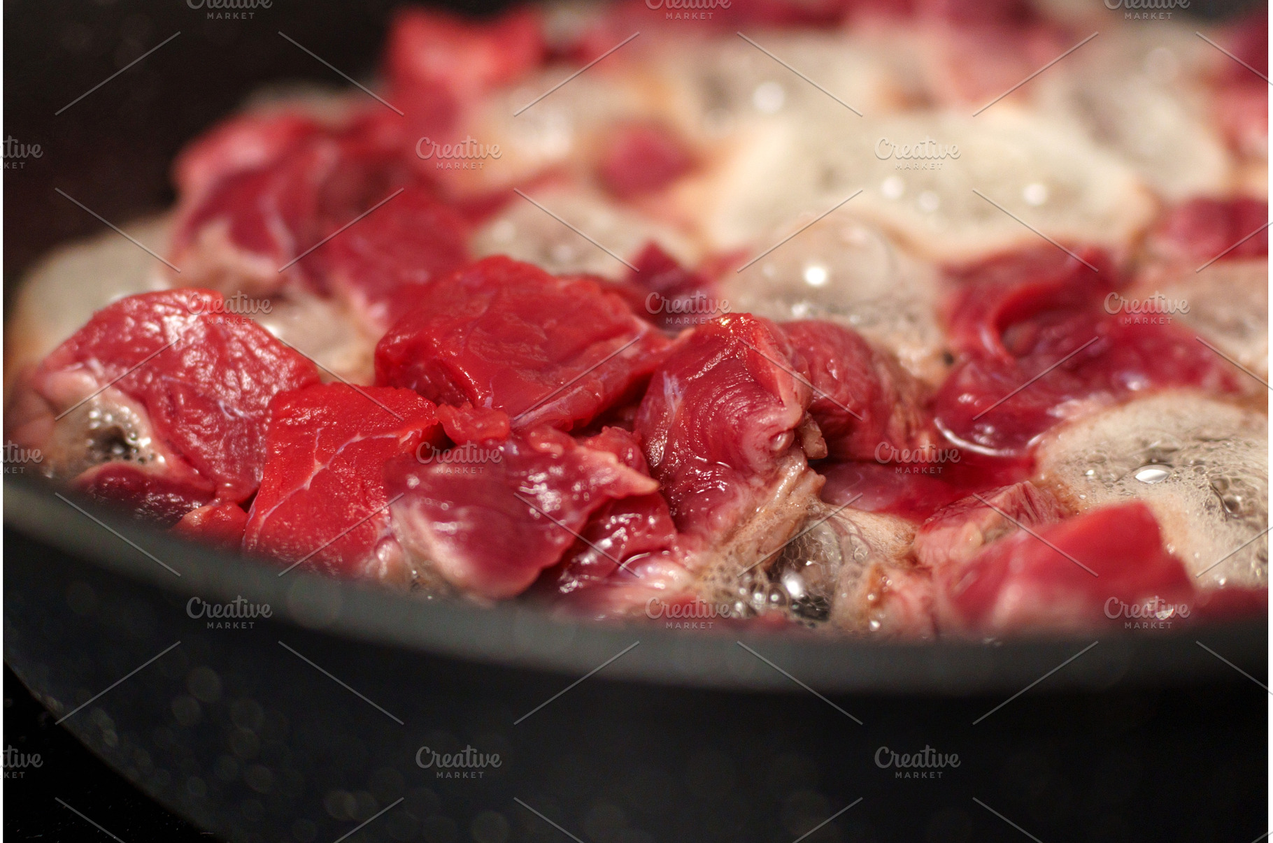 Chunks of raw beef are sizzling in a, a Food & Drink Photo by darksoul72