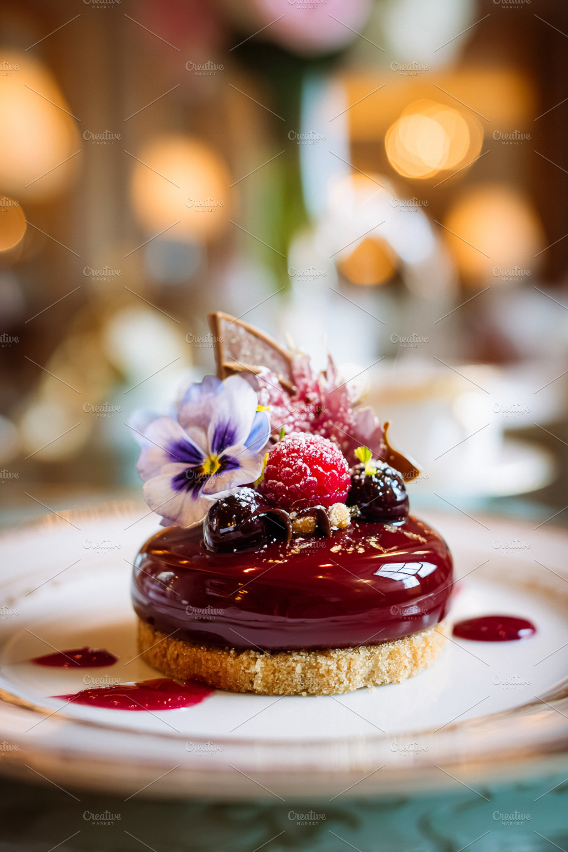 Gourmet berry dessert with edible flower garnish on a white plat, a Photo by Studio ANNA