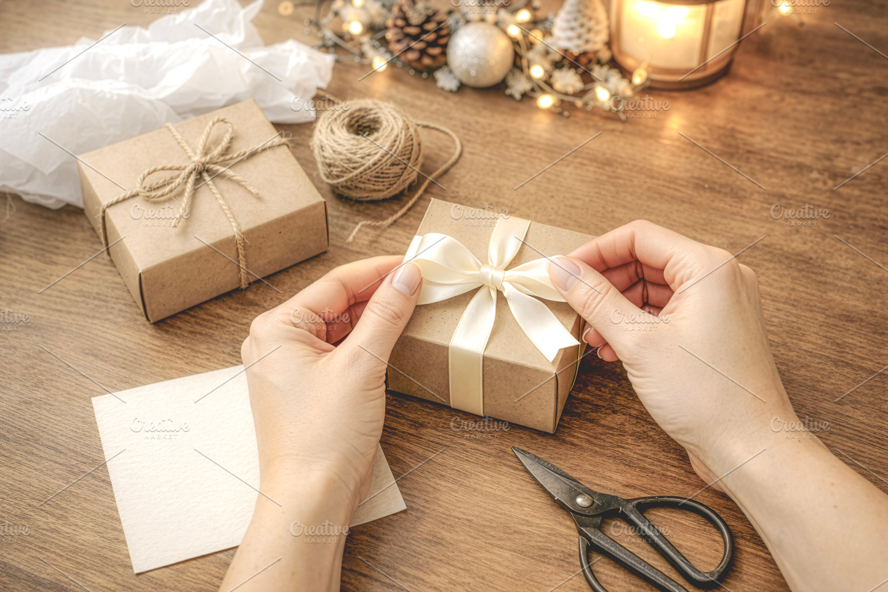 Hands wrapping Christmas gift box, a Photo by rarrarorro