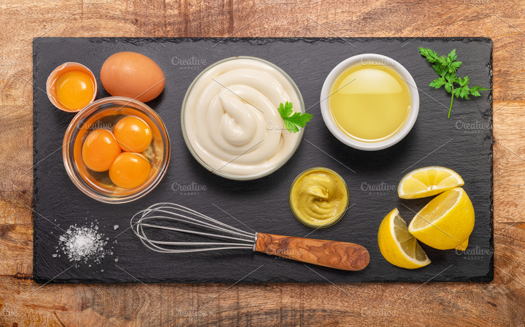 Homemade mayonnaise and mayo ingredients on black stone slate se, a Food & Drink Photo by Volff