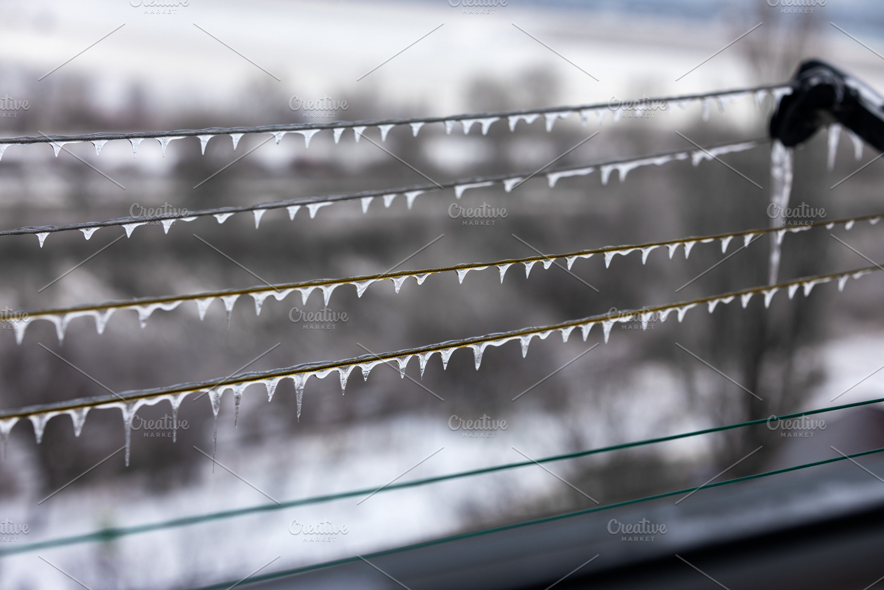 Close-up of icicles hanging from power lines in winter, with a b, an Architecture Photo by Ales Munt